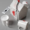 3d mug with drawing and container in the shape of a cardboard house.