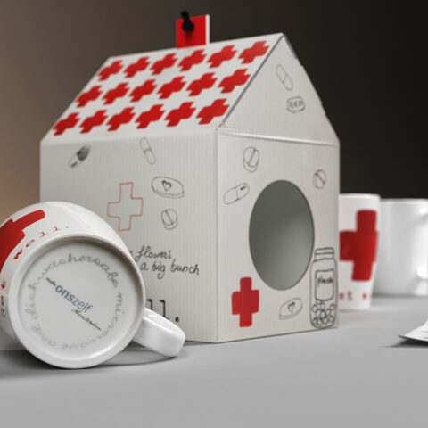 3d mug with drawing and container in the shape of a cardboard house.